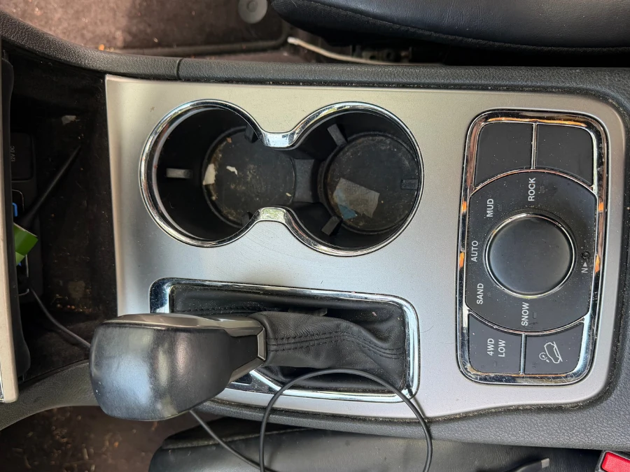Vehicle center console and cup holders before detailing — Grove City, Ohio