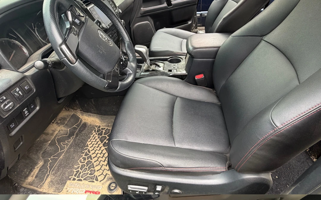 SUV front seats and muddy floor mat before detailing — Grove City, Ohio